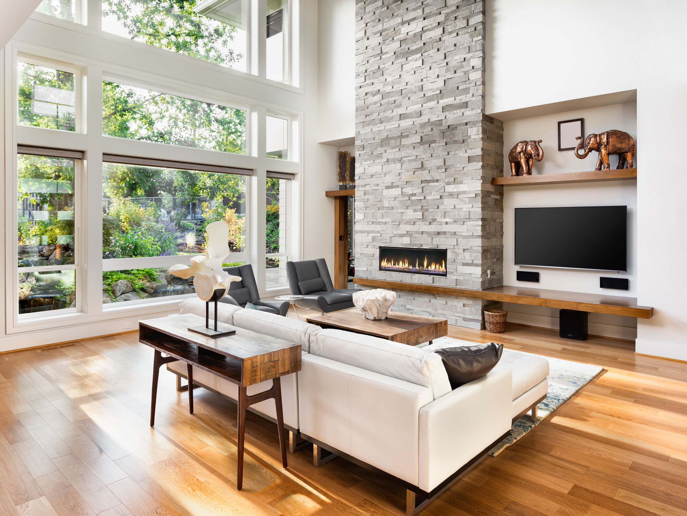 Beautiful living room with hardwood floors and fireplace in new luxury home